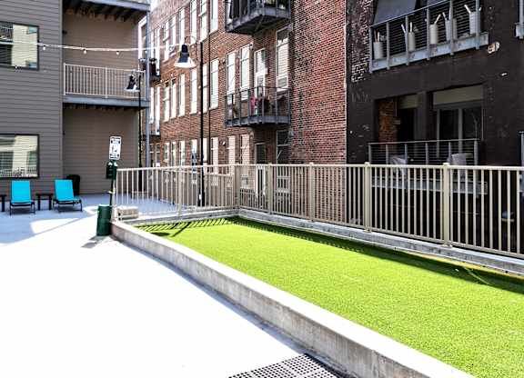 A small grassy area sits between two buildings.