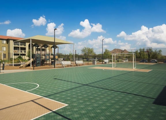 a tennis court with a building in the background