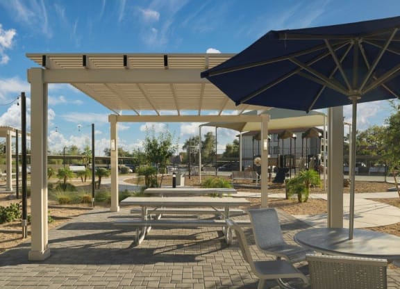 a picnic area with tables and umbrellas