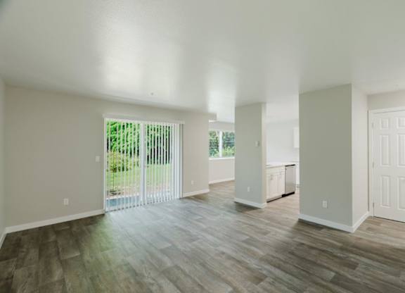 A room with wooden floors and white walls.