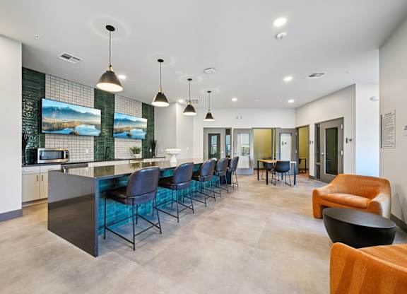 A modern kitchen with a bar area and seating.