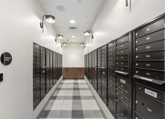 a long hallway with lockers in a room with a checkered floor