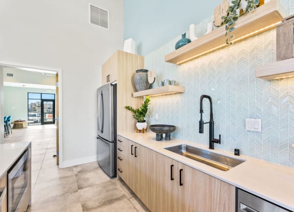 a kitchen with wooden cabinets and a sink and a refrigerator