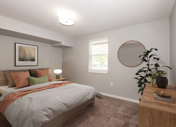 A bedroom with a bed, a lamp, a plant, and a picture on the wall.