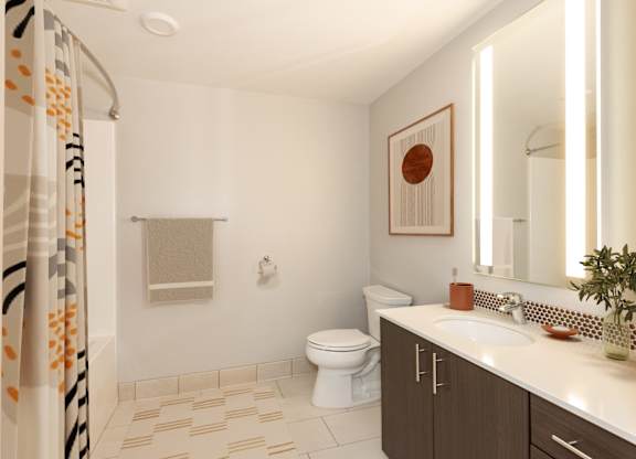 A bathroom with a toilet, sink, and shower.