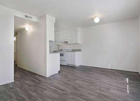 A kitchen area with a refrigerator, microwave, and oven.