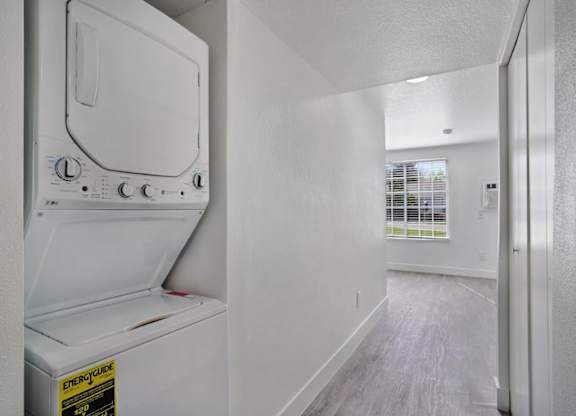 A white fridge in a room with a white wall.