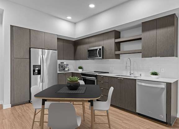 A modern kitchen with a table and chairs.