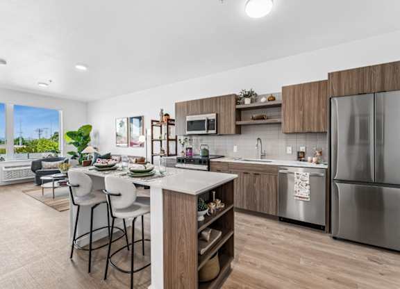 A modern kitchen with a dining table and chairs.