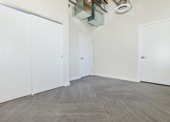 A room with white walls and a grey floor.