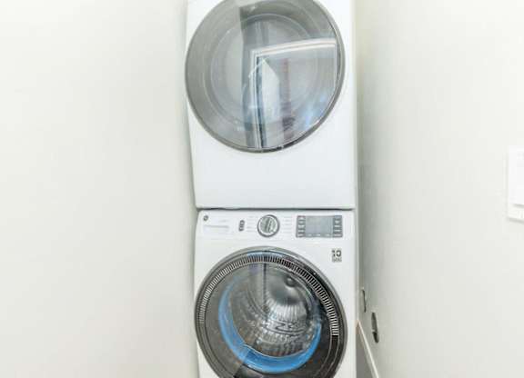 A white washing machine with a blue light on the front.