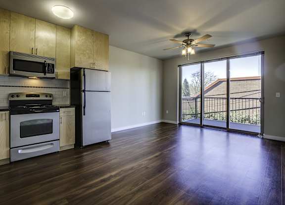 A kitchen with wooden cabinets and a refrigerator.