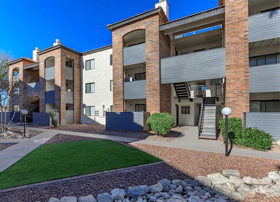 A modern apartment complex with a courtyard and landscaping.
