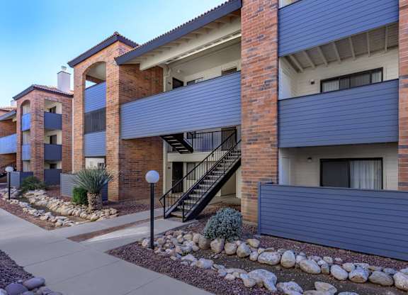 A modern apartment building with a staircase leading to the second floor.