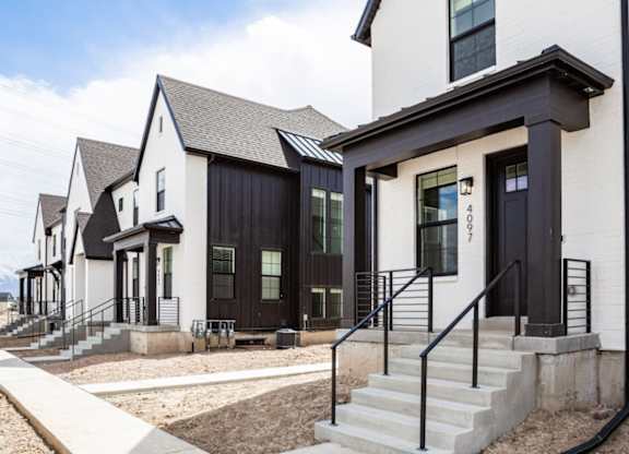 A row of modern houses with black and white exteriors.