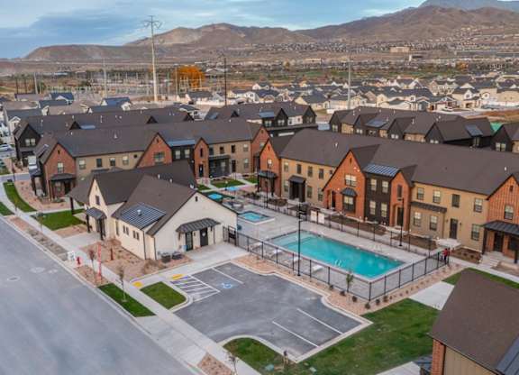 A large housing complex with a swimming pool in the middle.