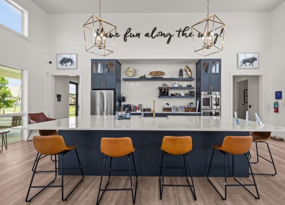a kitchen with a counter top and four chairs