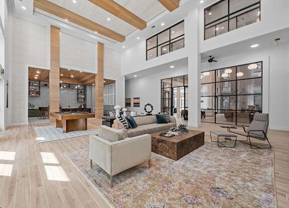 A spacious living room with a large rug and a sofa.