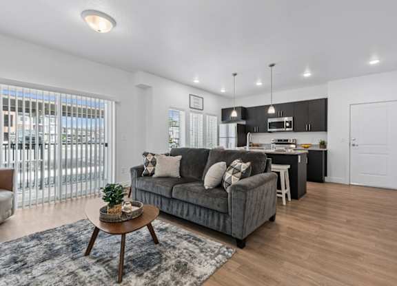 A modern living room with a grey sofa and a coffee table.