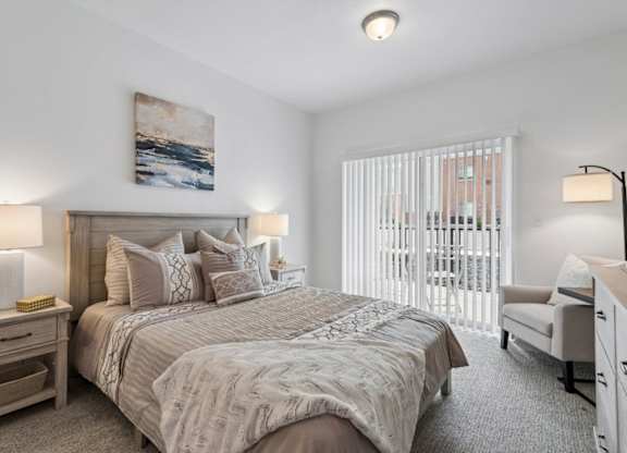A bedroom with a large bed and a painting on the wall.