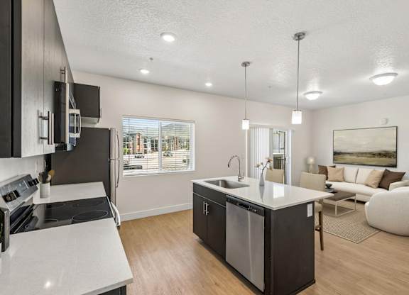 A modern kitchen with a large island and a view of the city.