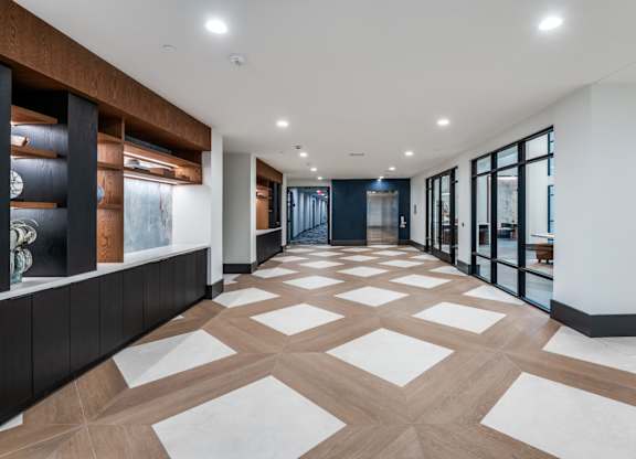 A long hallway with a white and brown checkered floor.