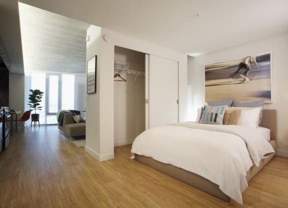 a bedroom with a bed and a chair in a room