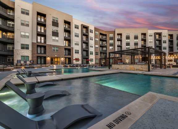 A modern building with a pool and a "No Diving" sign.
