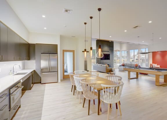a kitchen and dining room with a table and chairs