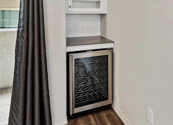 A kitchen with a stainless steel oven and a white cabinet.