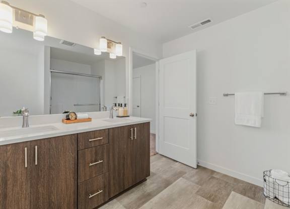 A bathroom with a white door and a white sink.