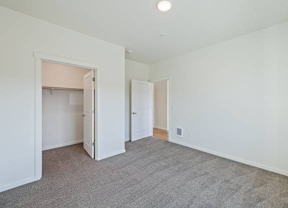 A room with white walls and a carpeted floor.