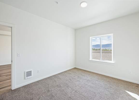 A room with a window showing a view of the outside.