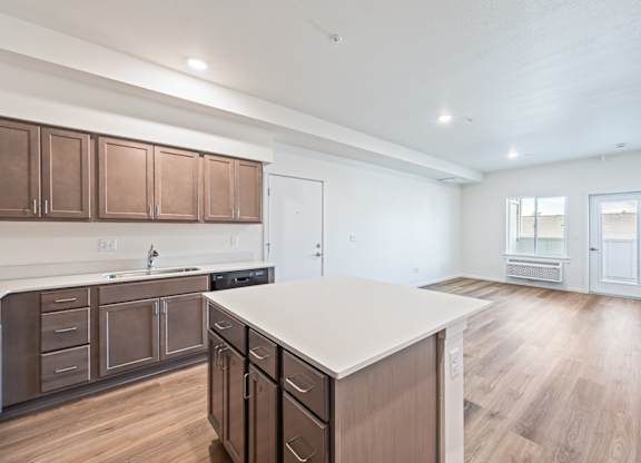 A kitchen with brown cabinets and a white countertop.