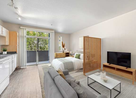 A modern living room with a grey sofa and a television.