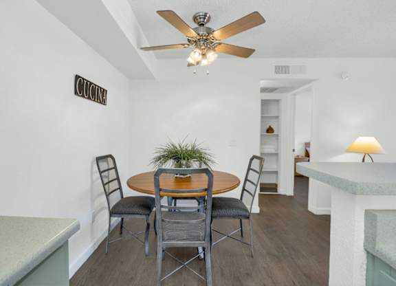 A dining room with a table and chairs.