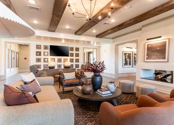 A living room with a fireplace and a TV mounted on the wall.