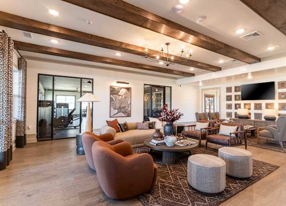 A living room with a brown chair and a grey ottoman.
