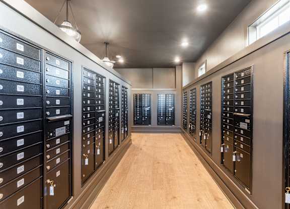 A long hallway with a row of mailboxes on each side.