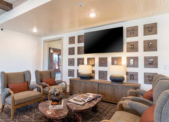 A living room with a couch, armchairs, and a coffee table.