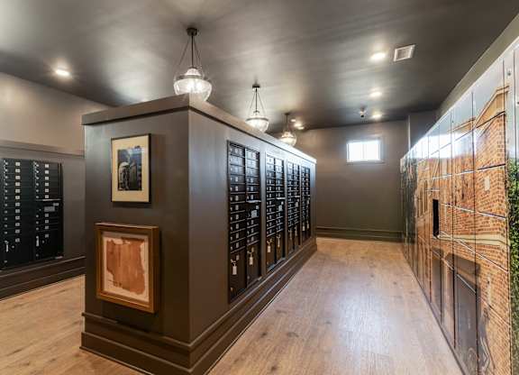 A room with a wooden floor and a wall of books.