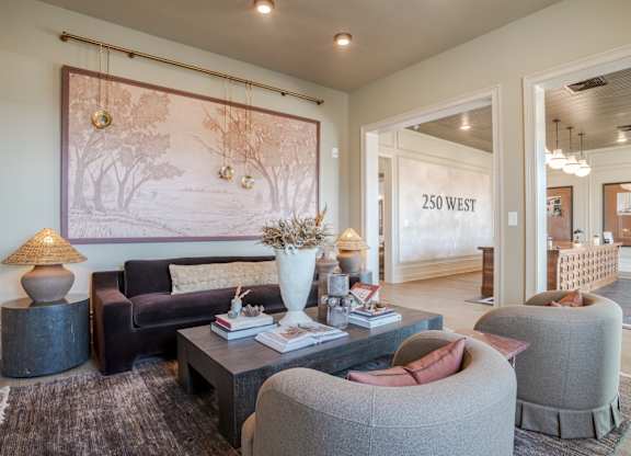A living room with a large painting on the wall and a sofa.