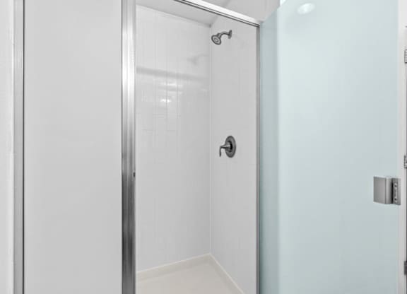 A white door with a silver handle and a silver lock.