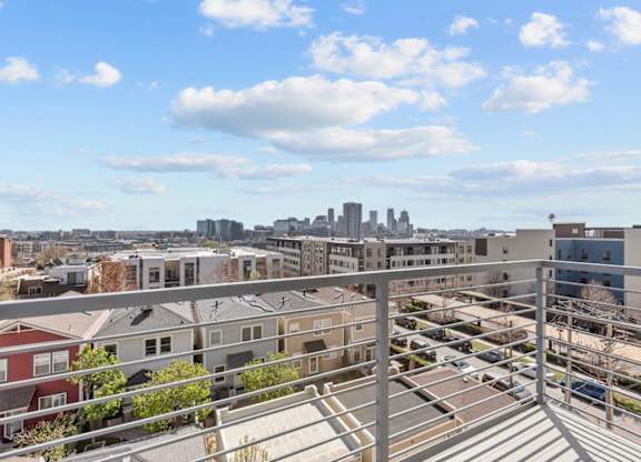 A cityscape is visible from a high vantage point.