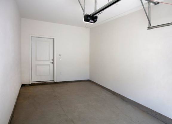 A room with a white door and a white wall.