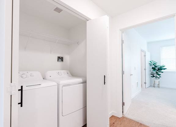 A white laundry room with a washer and dryer.
