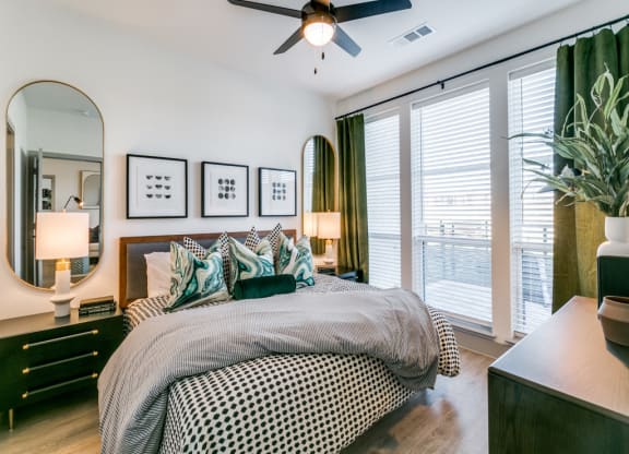 a bedroom with a large bed and a ceiling fan