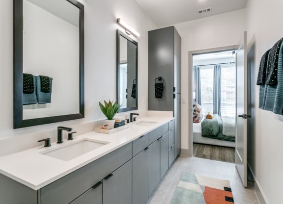a bathroom with two sinks and a mirror
