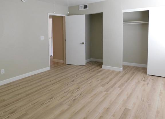 A room with a wooden floor and white walls.