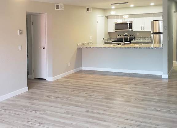 A kitchen area with a countertop and stainless steel appliances.